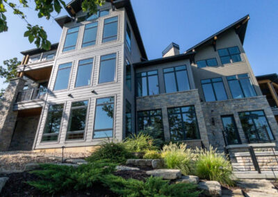 Modern lake home exterior with freshly washed siding and windows