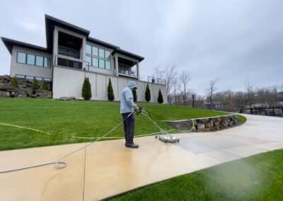 Worker pressure washing exterior surface with ClearView Windows